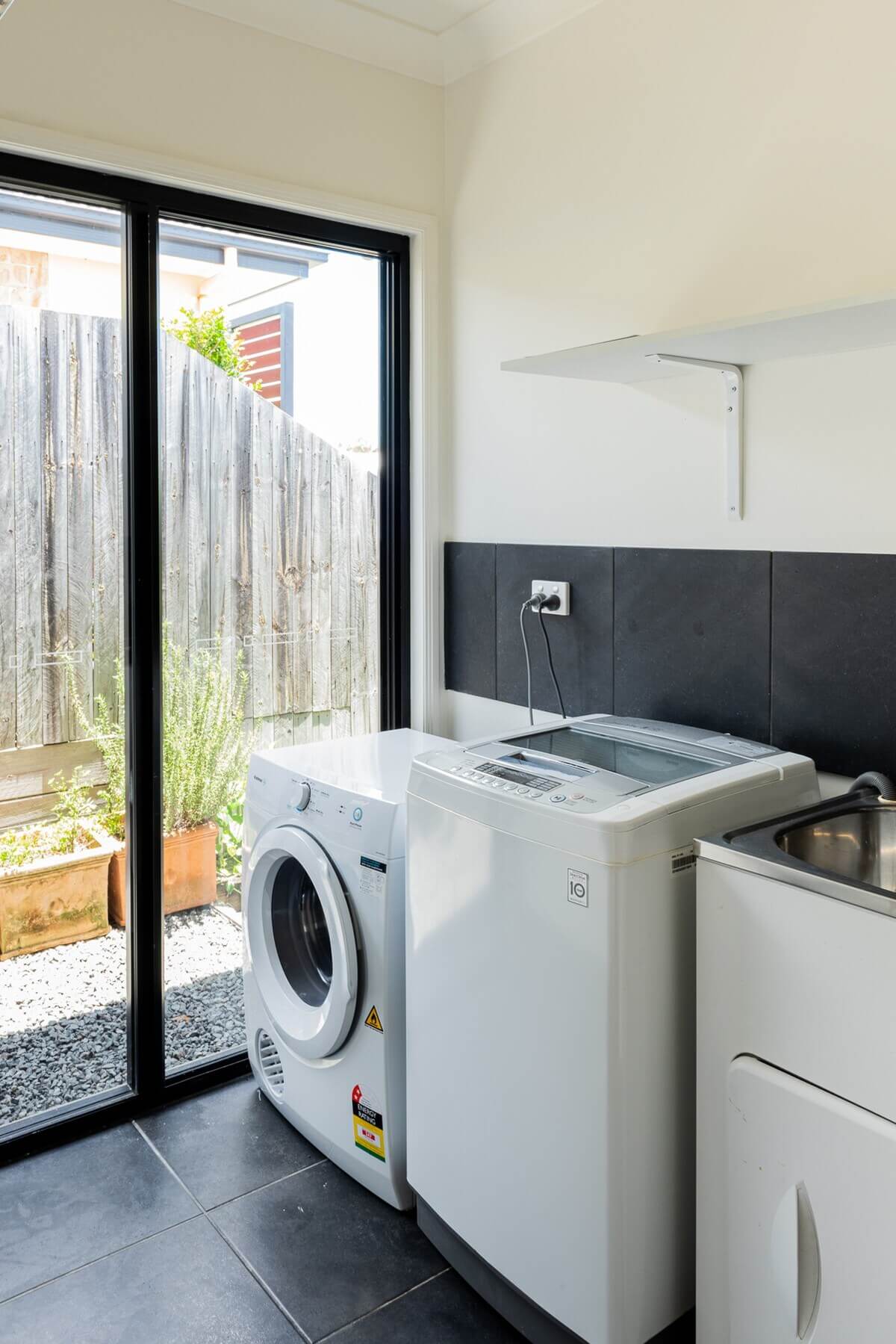 Laundry with washing machine, dryer, and clothes drying rack
